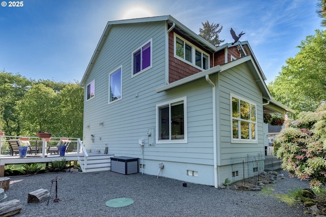 rear view of property with crawl space and a wooden deck