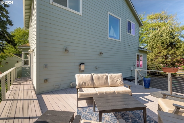 wooden deck with an outdoor living space