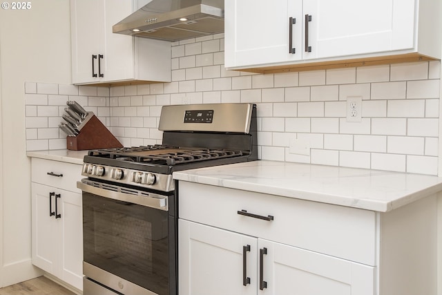 1540 Juniper St, Junction City, OR 97448 - kitchen featuring stainless steel gas range, ventilation hood, white cabinets, and light stone countertops