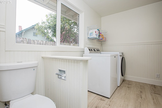 1540 Juniper St, Junction City, OR 97448 - laundry room featuring washer and clothes dryer, light wood finished floors, and a wainscoted wall