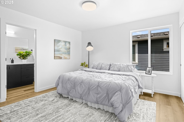 3528 NE 44th Ave, Portland, OR 97212 - bedroom featuring wood finished floors, baseboards, and ensuite bath