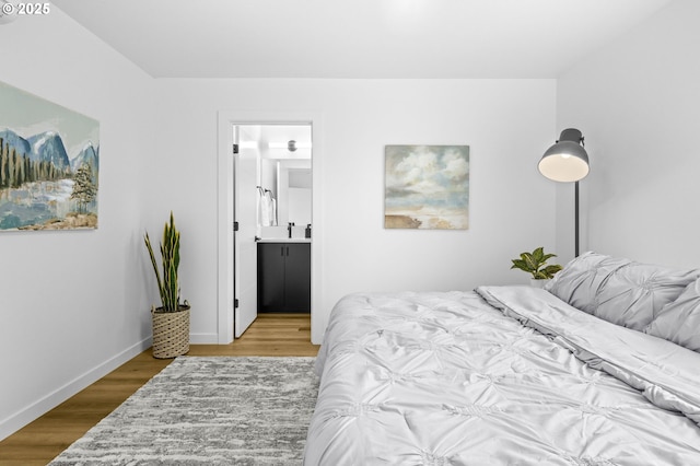 3528 NE 44th Ave, Portland, OR 97212 - bedroom featuring wood finished floors, baseboards, and ensuite bathroom