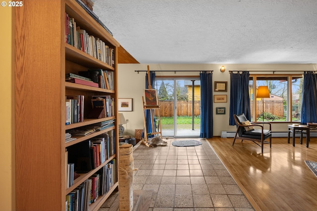 living area featuring a textured ceiling and wood finished floors