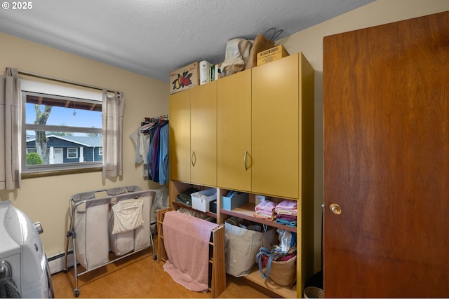 interior space with a baseboard heating unit, cabinet space, and a textured ceiling