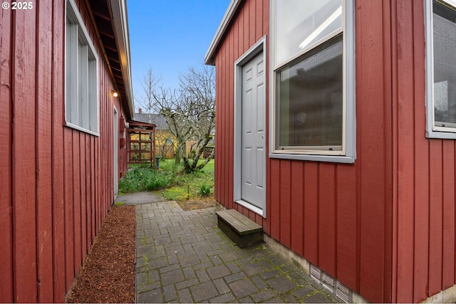 view of side of property featuring board and batten siding and entry steps