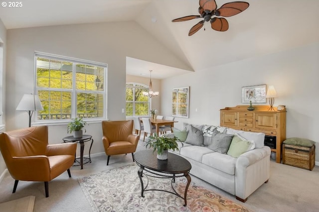 6395 Summerlinn Way W, Linn, OR 97068 - living room featuring light carpet, a ceiling fan, a chandelier, baseboards, and high vaulted ceiling