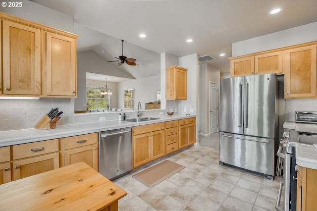 6395 Summerlinn Way W, Linn, OR 97068 - kitchen featuring appliances with stainless steel finishes, a sink, a ceiling fan, light countertops, and lofted ceiling