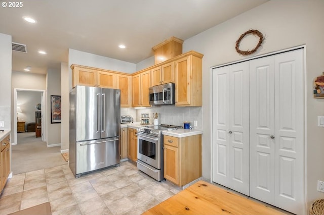 6395 Summerlinn Way W, Linn, OR 97068 - kitchen featuring appliances with stainless steel finishes, light brown cabinets, light countertops, backsplash, and baseboards