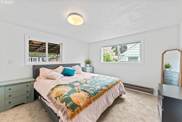bedroom featuring a baseboard heating unit and light colored carpet