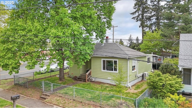 view of side of property featuring roof with shingles, entry steps, and fence private yard