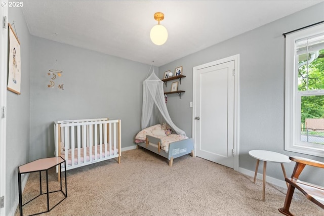 bedroom with carpet floors and baseboards