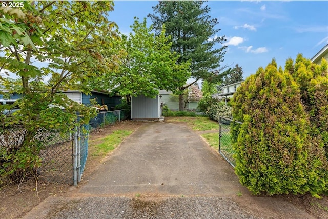 obstructed view of property with fence and a gate