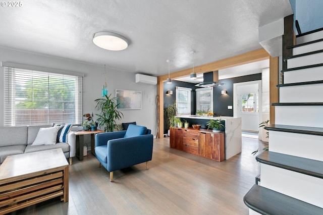 1090 Maple Dr, Eugene, OR 97404 - living area featuring stairs, light wood finished floors, a wall mounted AC, and plenty of natural light