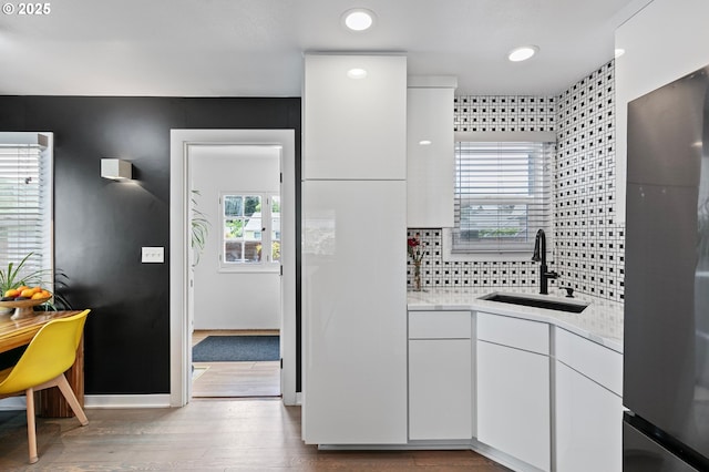 1090 Maple Dr, Eugene, OR 97404 - kitchen featuring a sink, fridge, light countertops, white cabinetry, and wood finished floors
