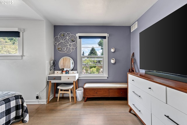 1090 Maple Dr, Eugene, OR 97404 - bedroom with multiple windows, wood finished floors, and baseboards