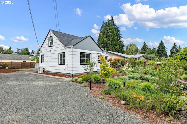 1090 Maple Dr, Eugene, OR 97404 - view of side of property with central AC unit and roof with shingles