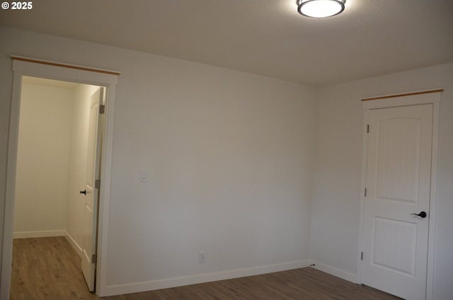 empty room with hardwood / wood-style floors