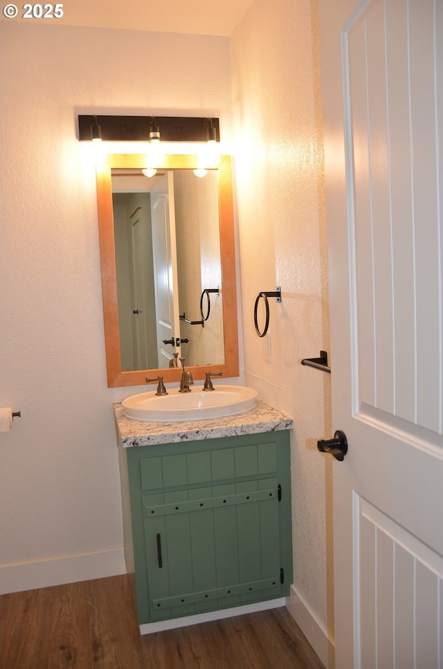 bathroom featuring hardwood / wood-style floors and vanity