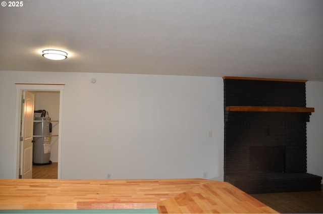 bedroom featuring dark wood-type flooring and a fireplace