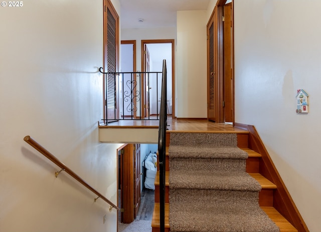 stairway featuring baseboards