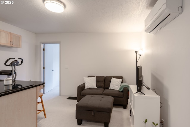 living area with a wall mounted air conditioner, light colored carpet, and a textured ceiling