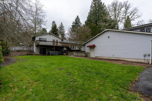 view of yard with a deck, a patio area, and fence