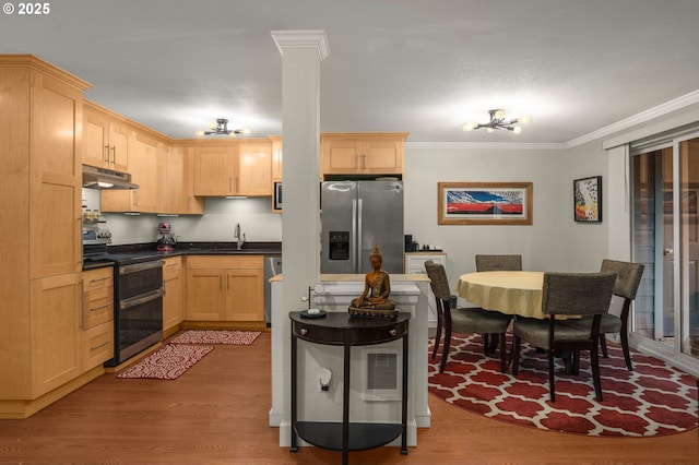 kitchen featuring sink, crown molding, appliances with stainless steel finishes, light hardwood / wood-style floors, and light brown cabinetry