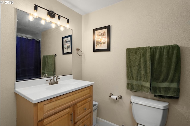 bathroom with vanity, a shower with shower curtain, and toilet