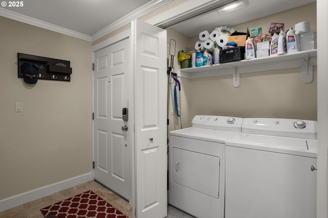 washroom featuring crown molding, washing machine and dryer, and light tile patterned floors