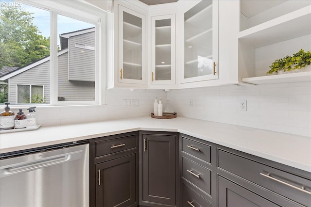 kitchen featuring stainless steel dishwasher, decorative backsplash, white cabinets, and open shelves