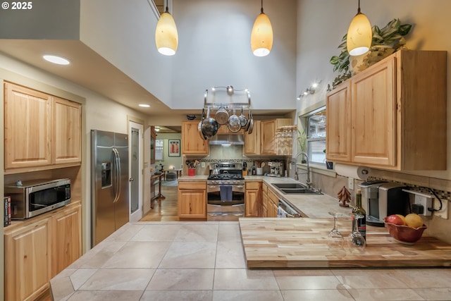 23830 Old Peak Rd, Philomath, OR 97370 - kitchen featuring appliances with stainless steel finishes, a sink, light tile patterned flooring, light countertops, and decorative backsplash