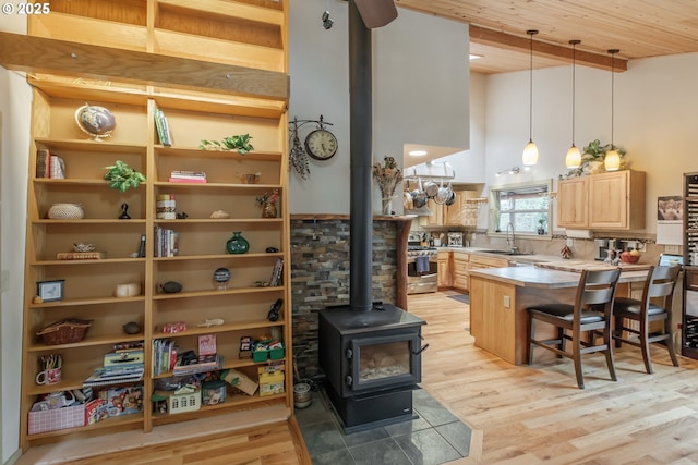 23830 Old Peak Rd, Philomath, OR 97370 - kitchen with a sink, light brown cabinetry, a high ceiling, a peninsula, and decorative light fixtures