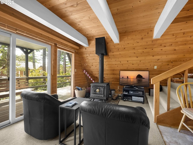 485 N Ave, Manzanita, OR 97130 - living area with wooden walls, a wood stove, stairs, a wooden ceiling with exposed beams, and carpet flooring