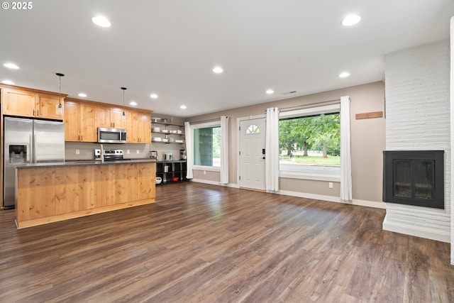 4607 SE 88th Ave, Portland, OR 97266 - kitchen with appliances with stainless steel finishes, dark countertops, open floor plan, recessed lighting, and an island with sink