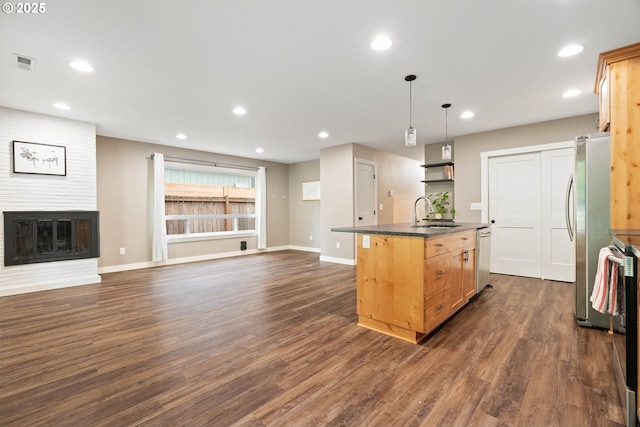 4607 SE 88th Ave, Portland, OR 97266 - kitchen featuring appliances with stainless steel finishes, dark countertops, a sink, dark wood finished floors, and open floor plan