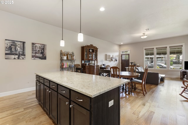 16033 SW 2nd St, Sherwood, OR 97140 - kitchen with light wood-type flooring, baseboards, hanging light fixtures, recessed lighting, and dark brown cabinetry