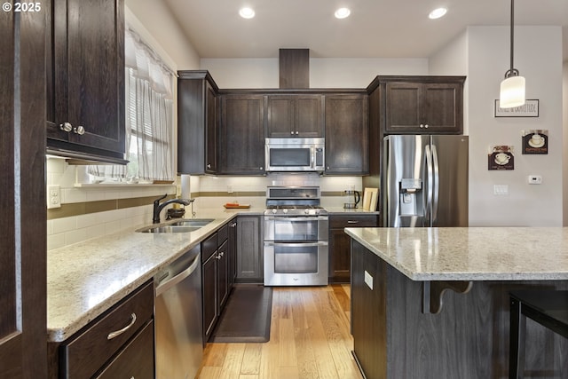 16033 SW 2nd St, Sherwood, OR 97140 - kitchen featuring stainless steel appliances, a sink, a kitchen bar, beverage cooler, and light wood-style floors
