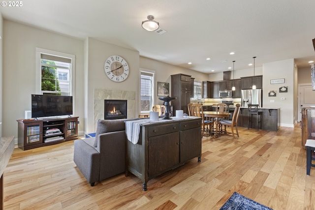 16033 SW 2nd St, Sherwood, OR 97140 - living area with plenty of natural light, light wood-style flooring, a fireplace, and recessed lighting