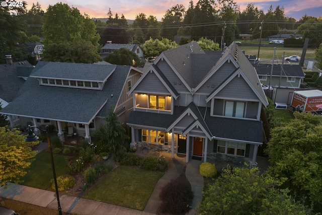 16033 SW 2nd St, Sherwood, OR 97140 - view of front of house featuring a front yard, a shingled roof, stone siding, and a porch