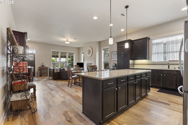 16033 SW 2nd St, Sherwood, OR 97140 - kitchen with light wood finished floors, recessed lighting, a kitchen island, and open floor plan