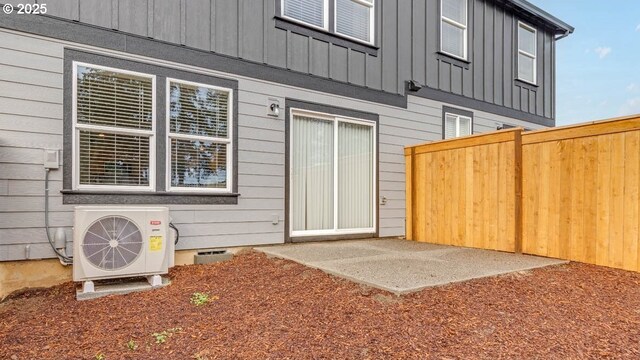 rear view of property featuring ac unit and a patio area