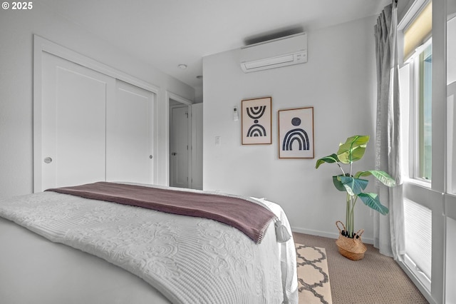 bedroom with a wall mounted air conditioner, carpet flooring, and a closet