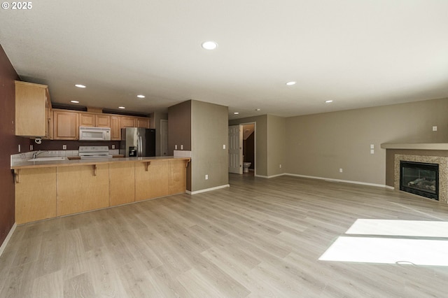 13924 NE 7th Ct, Vancouver, WA 98685 - kitchen featuring white appliances, open floor plan, a peninsula, baseboards, and recessed lighting