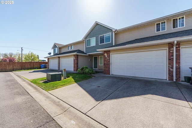 13924 NE 7th Ct, Vancouver, WA 98685 - multi unit property with concrete driveway, brick siding, and an attached garage