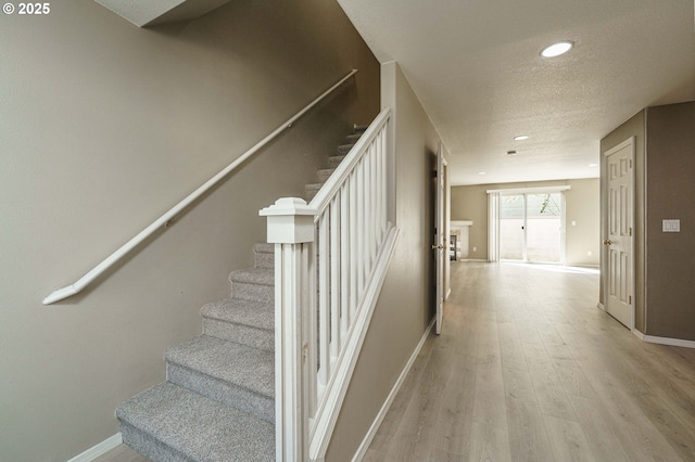 13924 NE 7th Ct, Vancouver, WA 98685 - stairs featuring wood finished floors, baseboards, recessed lighting, and a textured ceiling