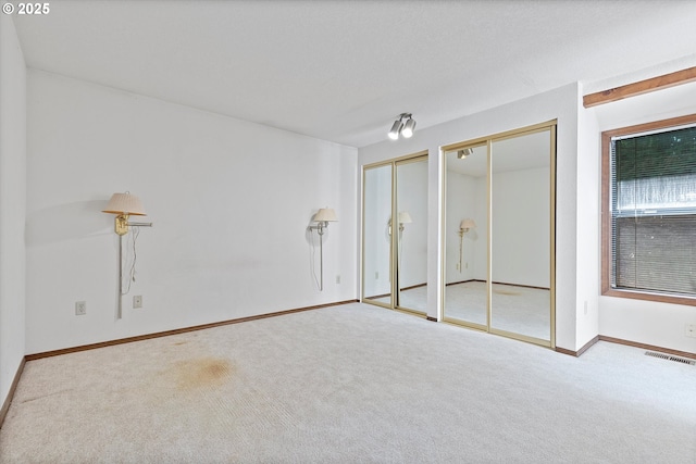 16445 SW Meadowood Way, Portland, OR 97224 - unfurnished bedroom featuring two closets and carpet flooring