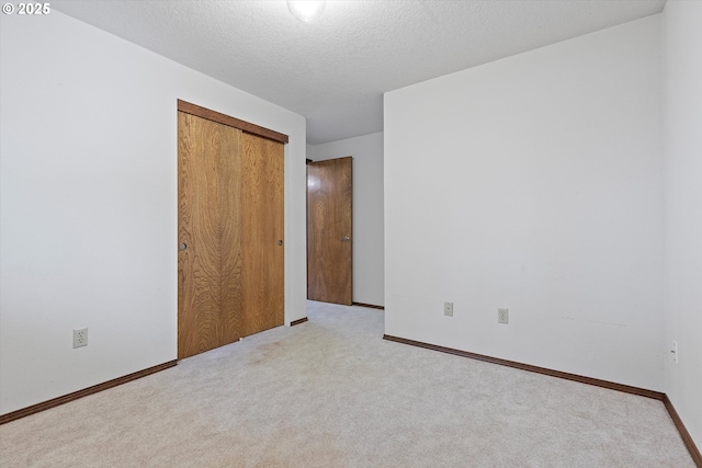 16445 SW Meadowood Way, Portland, OR 97224 - unfurnished bedroom with carpet, a closet, and a textured ceiling