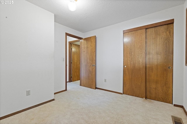16445 SW Meadowood Way, Portland, OR 97224 - unfurnished bedroom featuring light colored carpet, a closet, and a textured ceiling