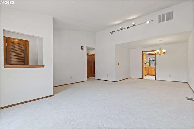 16445 SW Meadowood Way, Portland, OR 97224 - unfurnished room featuring a chandelier, light colored carpet, and lofted ceiling