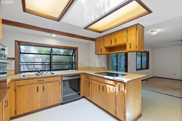 16445 SW Meadowood Way, Portland, OR 97224 - kitchen with black appliances, a peninsula, light countertops, light floors, and recessed lighting